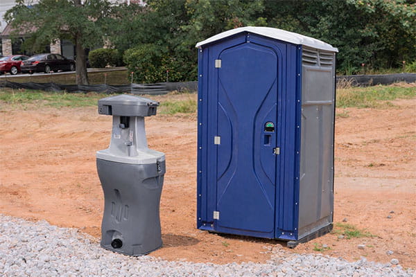 freestanding hand washing unit with sanitizer dispensers ready for use at a food truck festival